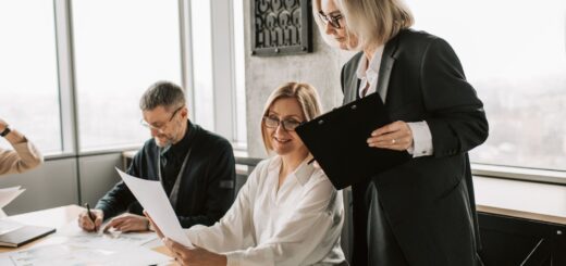 Colleagues discussing documents in an office; illustrative stock photograph