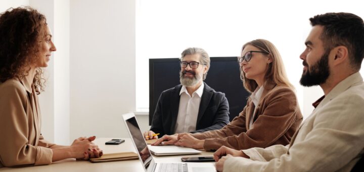Professionals discussing documents around an office table